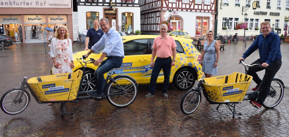 Personen auf dem Foto: auf den Rädern: Richard Schmitz (Geschäftsführer der MAINGAU Energie) und Erster Stadtrat Michael Gerheim, stehend von links nach rechts: Britta Sorg (Kreisverkehrsgesellschaft Offenbach mbH, Marketing), Karsten Munk (Projektleiter Elektromobilität MAINGAU), Bürgermeister Dr. Daniell Bastian, Monika Weber (Stadtmarketing)