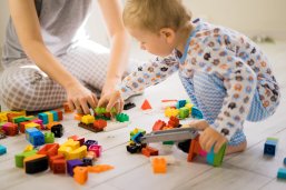 boy with mom playing in colorful building kit